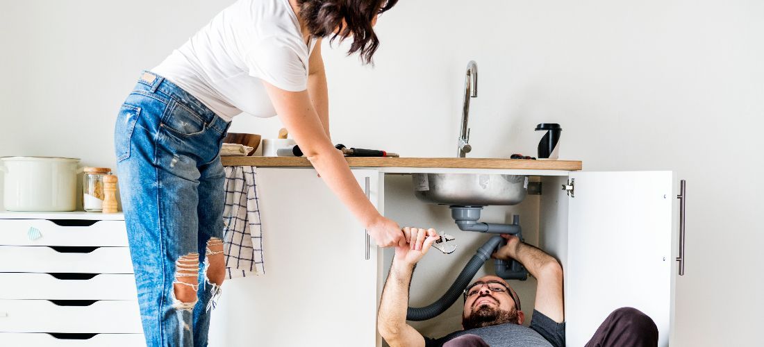 couple fitting a kitchen sink
