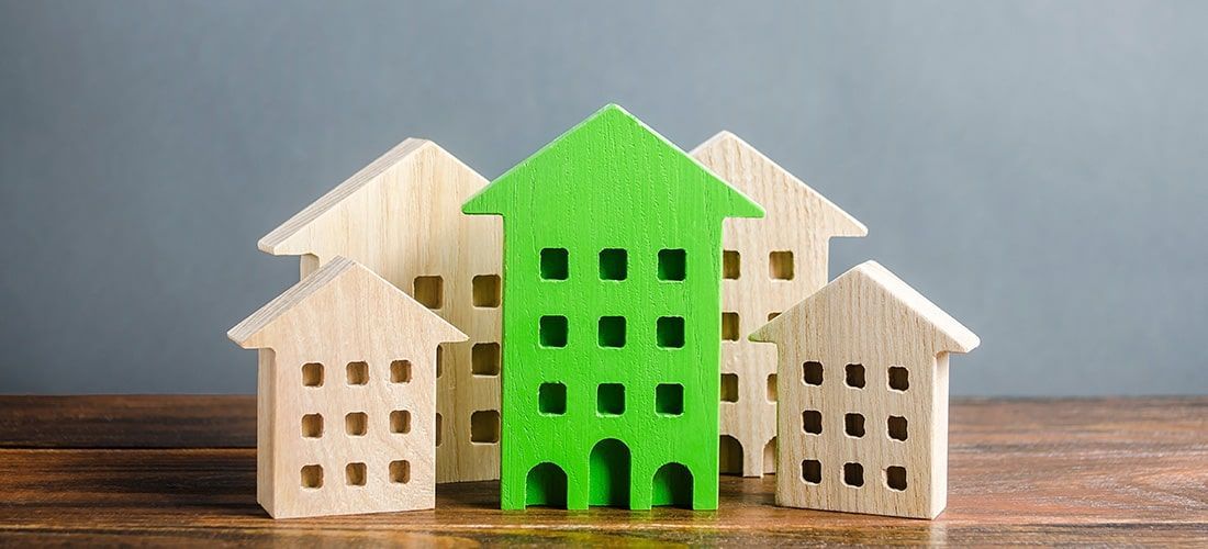 five house models with centre model painted green.
