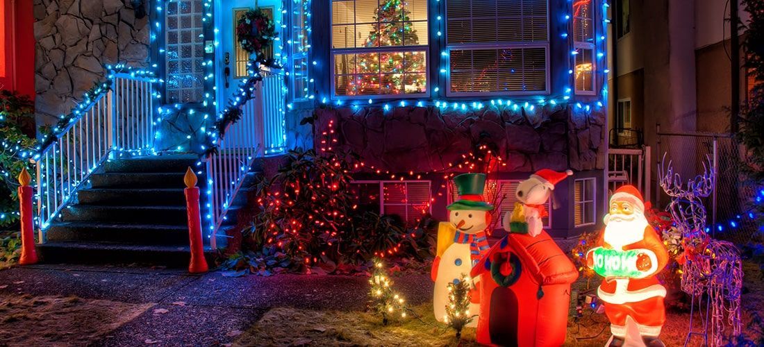 Festive Christmas lights and decorations outside home.