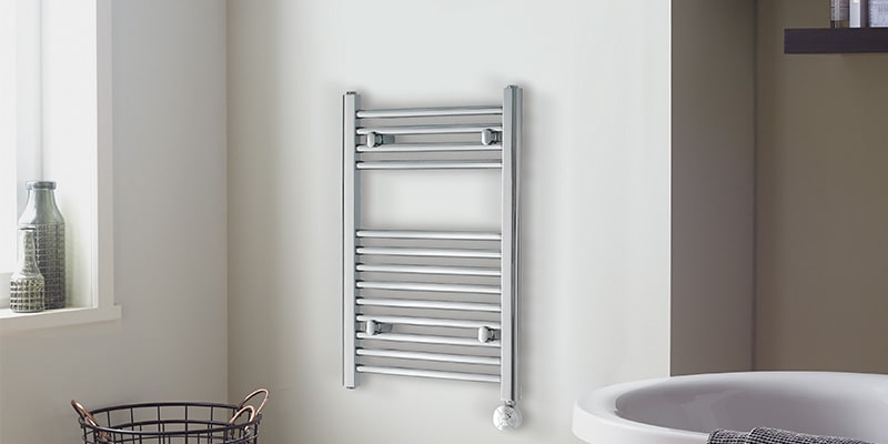 Stainless steel towel radiators hanging in bathroom.
