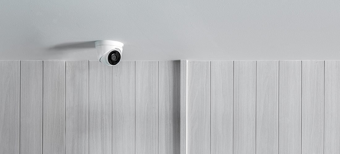 Security camera installed on interior ceiling.