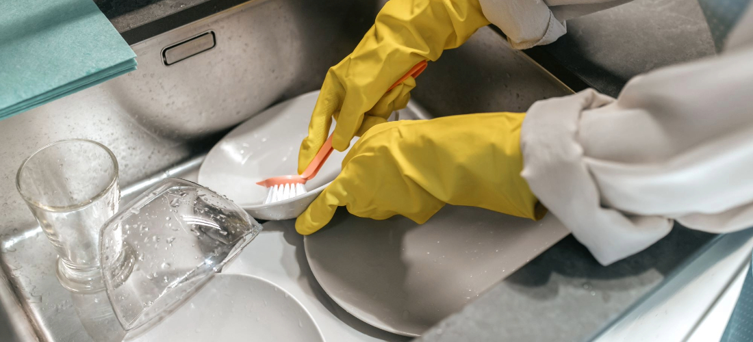 woman washing dishes in sink